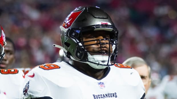 Buccaneers guard Shaq Mason runs off the field after a play.